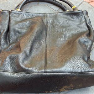 Black purse with zippers on the side